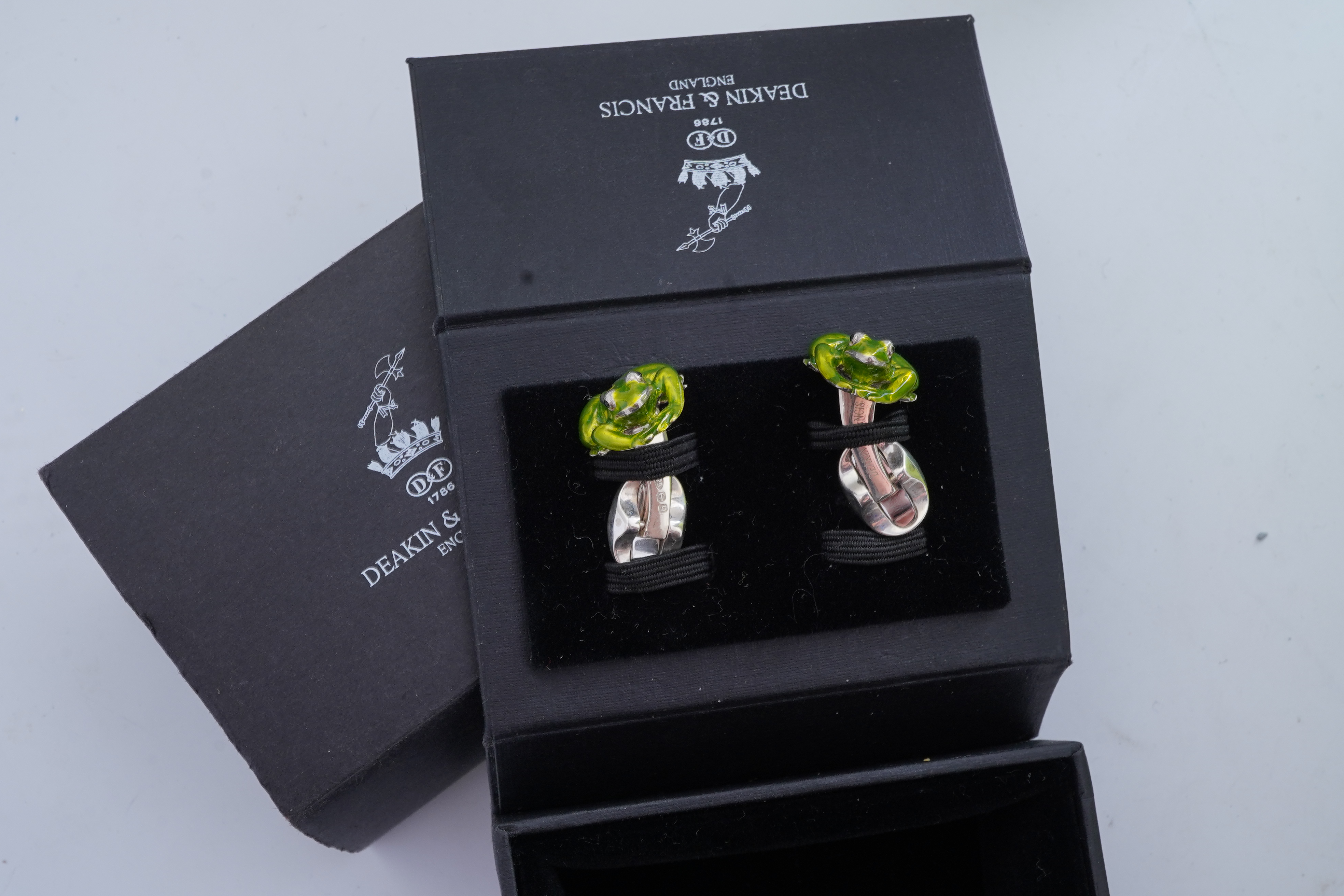 A modern pair of silver and polychrome enamel set oval cufflinks, 18mm.